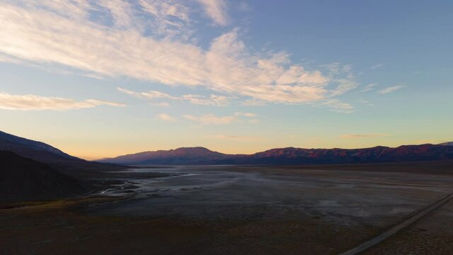 Aerial hyperlapse of sunrise sky over arid landscape in Death Valley in California