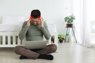Young man headaches for a long time from stressful work with laptop, Work from home concept.