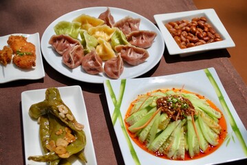 Colorful homemade dumplings with variety side dishes on table . Jiaozi. 
