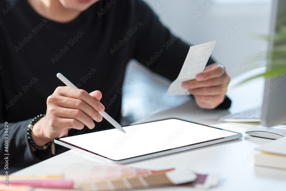 Poster man designer using a tablet and color graphics in their office design. blank white screen. mock up.