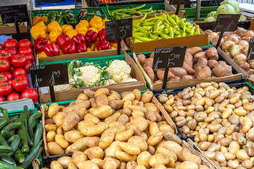Potatoes and other vegetables for sale at a market