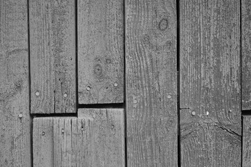 Closeup grayscale shot of an old vintage weathered plank wall texture