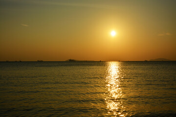 Fototapeta na wymiar golden sunset on the sea horizon in Sanya of Hainan