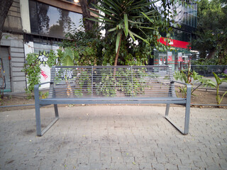 Fototapeta na wymiar Bench in the city streets, metal bench