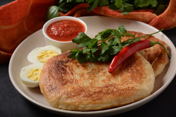 Traditional dishes of Israeli and Middle Eastern cuisine - Malawach with hard boiled eggs and...