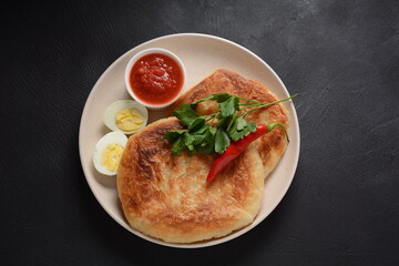 Traditional dishes of Israeli and Middle Eastern cuisine - Malawach with hard boiled eggs and...
