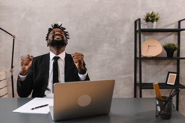 Black Businessman using laptop for analyzing data stock market, forex trading graph, stock exchange trading online, financial investment concept. close up
