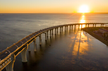 Fototapeta premium High-speed toll road, highway bypassing the city center St. Petersburg, the central section of the western high-speed section. A beautiful view of the sunset over the Gulf of Finland