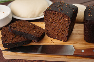 Sliced rye bread on brown wooden background