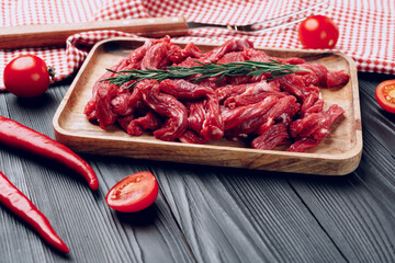 Raw beef meat fillet on wooden board