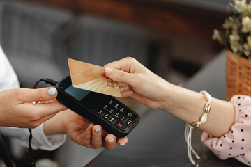 Close up of hand of customer paying with contactless credit card