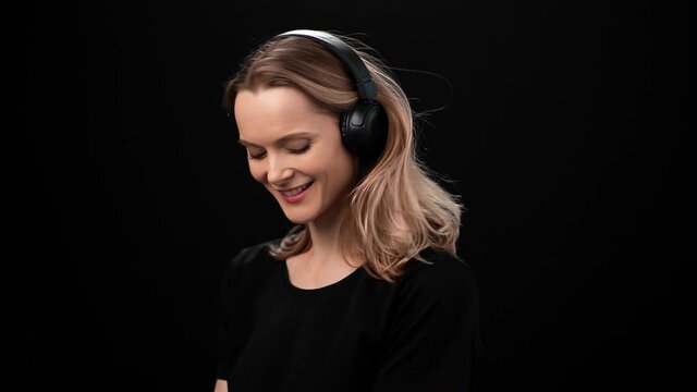Portrait of woman in headphones dancing enjoying audio sound isolated. Shot with RED camera in 4K