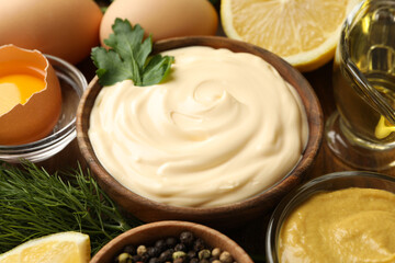 Wooden bowl of mayonnaise and ingredients for cooking