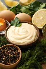 Wooden bowl of mayonnaise and ingredients for cooking