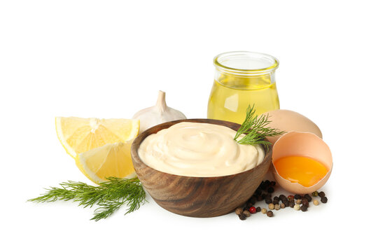 Bowl of mayonnaise and ingredients for cooking isolated on white background