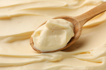 Mayonnaise sauce texture with wooden spoon, close up
