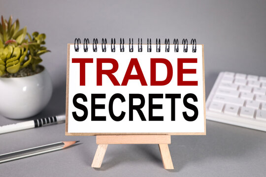 trade secrets, text on white paper on gray background