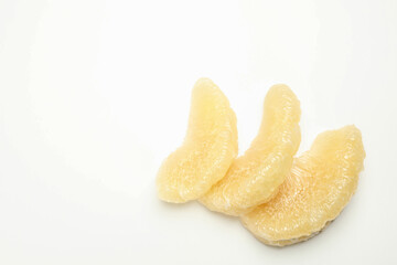 Ripe pomelo fruit slices on white background