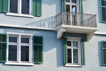 Balcony with shadow at a green house.