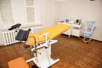 Gynecological chair in the clinic for artificial insemination and reproduction of women. Couch and...