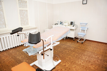 Gynecological chair in the clinic for artificial insemination and reproduction of women. Couch and...