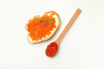 Sandwich and spoon with red caviar on white background