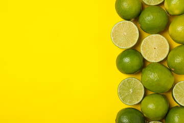 Ripe lime on yellow background, space for text