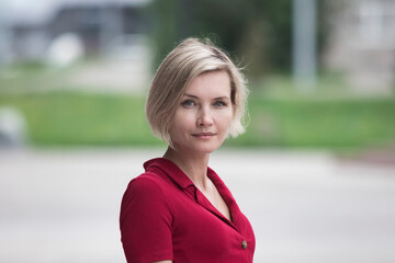 Portrait of a beautiful middle aged woman in a red dress