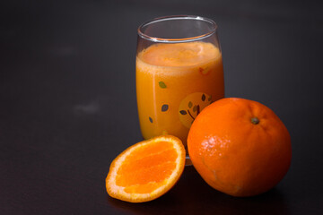 glass of orange juice on black background