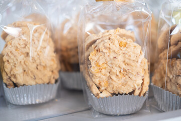 Cookies in plastic bags on shelf for sell at coffee shop.
