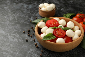 Concept of tasty eating with mozzarella cheese on black smokey background, space for text