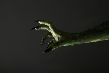 Scary monster on black background, closeup of hand. Halloween character © New Africa