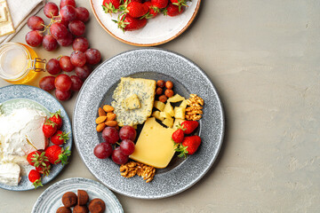 Composition of cheese, and fruits on gray table