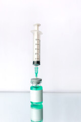Ampoule mockup. Syringe on white reflective surface. Healthcare and medical concept. Vaccine.