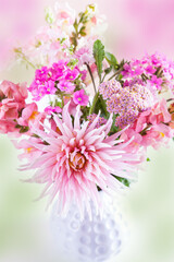 Summer pink garden flowers in a white vase. Summer composition