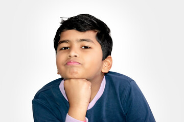 Cute Indian kid boy looking at camera on isolated white background