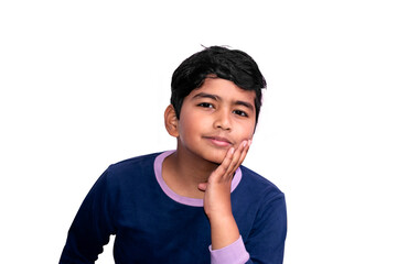 Portrait of a little Asian Indian boy looking at the camera hand under chin isolated on white background.