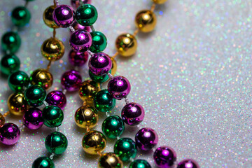 Macro defocused abstract view of traditional three-color Mardi Gras beaded costume jewelry...
