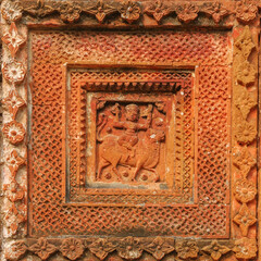 Carved terracotta scene of Durga riding Nandi bull  on beautiful ancient Chauchala Chhota Govinda Mandir in Puthia temple complex, Rajshahi district, Bangladesh