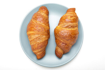 Plate with tasty croissants on white background. French pastry