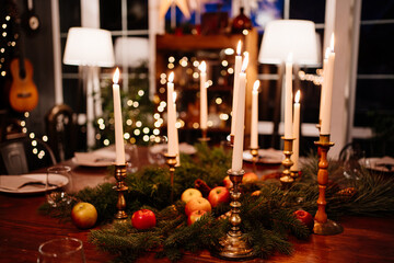 burning candles in candlesticks in a dark interior. romantic dinner. New Year