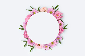 Round frame made of eustoma and aster on a blue background. Gentle flower wreath.