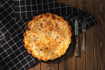 apple pie on a wooden background. Rustic style.
