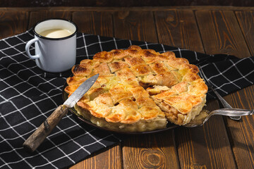 apple pie with milk on a wooden background. Rustic style.