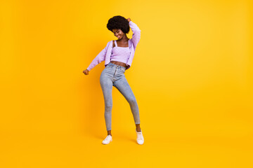 Fototapeta na wymiar Full length photo of attractive dark skin lady dance have great weekend wear violet isolated on yellow color background