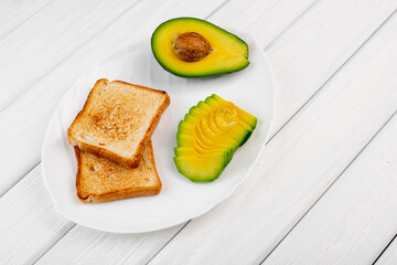 Tasty avocado sandwiches on table