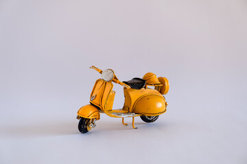 Old toy motorbike on different backgrounds