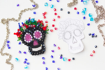 Brooch skull in style of los muertos made of beads and felt, glass beads and sequins 
