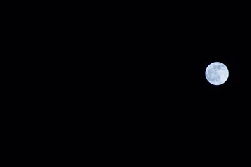 Full moon over dark night sky