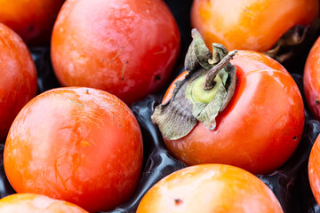 persimmons in a crate close up